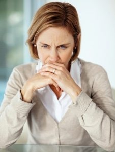 Disappointed mature businessswoman thinking over something